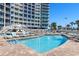 Beautiful outdoor pool with lounge chairs provides relaxation and is adjacent to the resort building at 300 N Ocean Blvd. # 128, North Myrtle Beach, SC 29582
