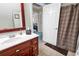 Bathroom featuring a cherry-wood vanity and a shower with a patterned curtain at 315 14Th Ave. N, Surfside Beach, SC 29575