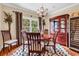 Dining area featuring hardwood floors, modern rug, and an elegant china cabinet at 315 14Th Ave. N, Surfside Beach, SC 29575