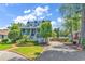 Charming home with a well-manicured front yard, featuring a gravel driveway and inviting porch with white railings at 315 14Th Ave. N, Surfside Beach, SC 29575