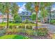 Charming two-story home with a manicured front yard, lush landscaping, and beautiful curb appeal framed by palm trees at 315 14Th Ave. N, Surfside Beach, SC 29575