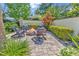 Cozy outdoor fire pit area with Adirondack chairs, brick patio, and well-manicured landscaping at 315 14Th Ave. N, Surfside Beach, SC 29575