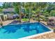 Aerial shot of a backyard showcasing a sparkling pool, hot tub, and meticulously landscaped outdoor space at 315 14Th Ave. N, Surfside Beach, SC 29575