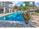 Stunning pool area with brick patio, lush landscaping, and bright red flowers for a relaxing backyard oasis at 315 14Th Ave. N, Surfside Beach, SC 29575