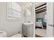 Charming bathroom with sink and storage, complemented by view into cozy bedroom with beamed ceiling at 325 N 58Th Ave. N, North Myrtle Beach, SC 29582