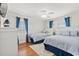 Bright bedroom features two twin beds, hardwood floors, and stylish blue accents at 325 N 58Th Ave. N, North Myrtle Beach, SC 29582
