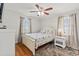 Serene bedroom with hardwood floors, a ceiling fan, and natural light from two windows at 325 N 58Th Ave. N, North Myrtle Beach, SC 29582