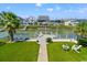 Beautiful backyard with synthetic grass and a canal-front dock with chairs at 325 N 58Th Ave. N, North Myrtle Beach, SC 29582