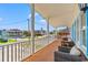 Inviting covered front porch with wicker seating, perfect for enjoying neighborhood views at 325 N 58Th Ave. N, North Myrtle Beach, SC 29582