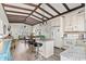 Open kitchen with island seating, wooden floors, and bright natural light flowing into the dining area at 325 N 58Th Ave. N, North Myrtle Beach, SC 29582