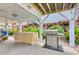 Outdoor patio featuring a grill, tiki table, and shaded seating area for relaxed outdoor entertaining at 325 N 58Th Ave. N, North Myrtle Beach, SC 29582