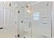 Clean, bright shower with sliding glass doors and built-in shelving at 325 N 58Th Ave. N, North Myrtle Beach, SC 29582