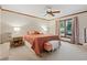 Cozy bedroom features a large window, ceiling fan, and comfortable furnishings at 3533 Lighthouse Way, Myrtle Beach, SC 29577