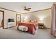 Comfortable bedroom featuring a ceiling fan, ensuite bathroom, and plush carpet at 3533 Lighthouse Way, Myrtle Beach, SC 29577