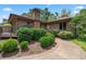 Home's exterior features lush landscaping, a brick chimney, and a paved walkway at 3533 Lighthouse Way, Myrtle Beach, SC 29577