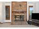 Close up on the brick fireplace, flanked by windows and display shelving at 3533 Lighthouse Way, Myrtle Beach, SC 29577