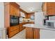 Well-lit kitchen with wooden cabinets and updated appliances for modern convenience at 3533 Lighthouse Way, Myrtle Beach, SC 29577