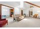 Bright living room featuring a beige couch, skylight, and multiple doorways at 3533 Lighthouse Way, Myrtle Beach, SC 29577