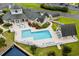 Aerial view of community pool, clubhouse, and surrounding landscaped grounds at 3835 Masters Ct. # 135, Myrtle Beach, SC 29577