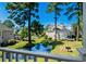 Scenic view of a lush backyard with a pond and mature trees in a tranquil setting at 3835 Masters Ct. # 135, Myrtle Beach, SC 29577