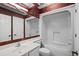 Bathroom with patterned wallpaper, white vanity, and a shower-tub combo at 3835 Masters Ct. # 135, Myrtle Beach, SC 29577
