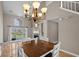 Bright dining room featuring a large window, chandelier, and open access to the living room at 3835 Masters Ct. # 135, Myrtle Beach, SC 29577
