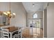 Dining room with a chandelier, vaulted ceiling, and sliding glass doors to a patio at 3835 Masters Ct. # 135, Myrtle Beach, SC 29577