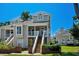 Charming townhouse with a welcoming entrance, staircase, and manicured landscaping at 3835 Masters Ct. # 135, Myrtle Beach, SC 29577