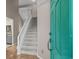 Inviting foyer with hardwood floors, a staircase, and a brightly colored front door at 3835 Masters Ct. # 135, Myrtle Beach, SC 29577