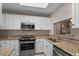 Kitchen showcasing stainless steel appliances, granite countertops, and white cabinets at 3835 Masters Ct. # 135, Myrtle Beach, SC 29577