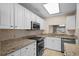 Kitchen showcasing stainless steel appliances, granite countertops, and white cabinetry at 3835 Masters Ct. # 135, Myrtle Beach, SC 29577
