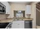 Kitchen area with granite countertops and stainless steel appliances and white cabinetry at 3835 Masters Ct. # 135, Myrtle Beach, SC 29577
