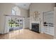 Inviting living room with a fireplace, built-in shelves, and a view of the screened-in patio at 3835 Masters Ct. # 135, Myrtle Beach, SC 29577