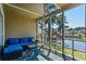 Relaxing screened porch with a comfortable blue couch overlooking the picturesque waterfront at 3835 Masters Ct. # 135, Myrtle Beach, SC 29577