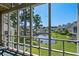 Peaceful view of a pond and lush greenery from the screened-in porch, creating a serene retreat at 3835 Masters Ct. # 135, Myrtle Beach, SC 29577