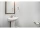 Bathroom featuring a pedestal sink with modern faucet, mirror, and neutral decor at 4051 Mclamb Ave. # 4051, Little River, SC 29566