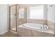 Bathroom featuring soaking tub and glass enclosed shower, providing a spa-like feel at 4051 Mclamb Ave. # 4051, Little River, SC 29566