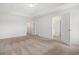 Spacious bedroom with neutral carpet and multiple doorways to bathroom and closet at 4051 Mclamb Ave. # 4051, Little River, SC 29566