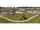 Expansive aerial view of the community amenities including the pool, clubhouse, and pond, surrounded by green landscaping at 4051 Mclamb Ave. # 4051, Little River, SC 29566
