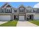 Charming townhomes featuring a mix of siding and brick accents, complemented by well-manicured lawns and a bright sky at 4051 Mclamb Ave. # 4051, Little River, SC 29566
