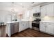 Modern kitchen with stainless steel appliances, quartz countertops, and stylish backsplash tiles at 4051 Mclamb Ave. # 4051, Little River, SC 29566