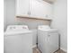 Bright laundry room with white cabinets and appliances including a washer and dryer at 4051 Mclamb Ave. # 4051, Little River, SC 29566