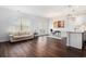 Open living area with hardwood floors, leading to a dining space and kitchen with bright natural light at 4051 Mclamb Ave. # 4051, Little River, SC 29566