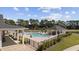 A serene pool area with lounge chairs, cabana, and lush landscaping under a sunny sky, ideal for relaxation at 4051 Mclamb Ave. # 4051, Little River, SC 29566
