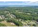Breathtaking aerial view of the coastal community with lush trees, a pond, and partial ocean view at 4539 Fringetree Dr., Murrells Inlet, SC 29576