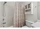 Bright bathroom showcasing a shower with curtain, vanity, medicine cabinet, and white fixtures at 4539 Fringetree Dr., Murrells Inlet, SC 29576