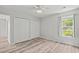 Light-filled bedroom has a ceiling fan, a double-door closet, and a window overlooking the front yard at 4539 Fringetree Dr., Murrells Inlet, SC 29576