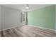 Neutral bedroom boasts a ceiling fan, light grey walls and light-colored wood floors for a modern design at 4539 Fringetree Dr., Murrells Inlet, SC 29576