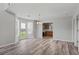Open dining area featuring wood-look floors, modern lighting, and easy access to both the kitchen and backyard at 4539 Fringetree Dr., Murrells Inlet, SC 29576