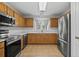 Modern kitchen with stainless steel appliances, quartz countertops, and wood cabinets for a sleek design at 4539 Fringetree Dr., Murrells Inlet, SC 29576